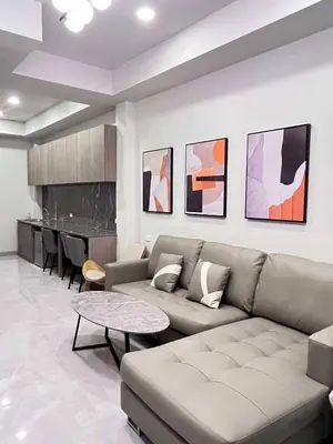 a living room with a couch and a table at Pipp Residence in Bangkok