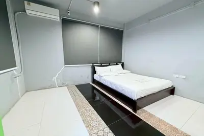 a small room with a bed in a room at Sukhum Huai Khwang Guest House in Bangkok