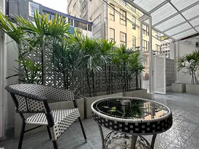 a patio with a table and chairs and plants at Bunya House near BTS Asok, Terminal21 Free BF in Bangkok
