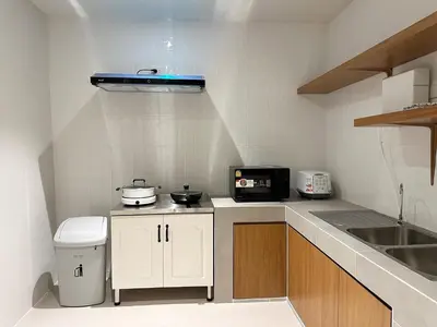 a small kitchen with a counter and a sink at Bunya House near BTS Asok, Terminal21 Free BF in Bangkok