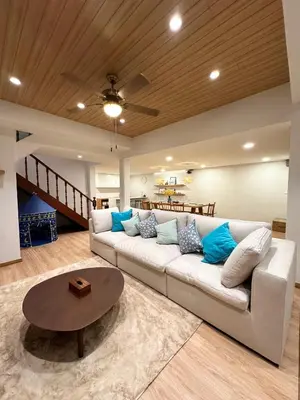 a living room with a white couch and a table at Bunya House near BTS Asok, Terminal21 Free BF in Bangkok