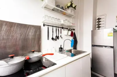 a kitchen with a sink and a refrigerator at MIQ_5br/Silom Bts,Mrt/Wifi 1000MB/Jacuzzi/16pax in Bangkok