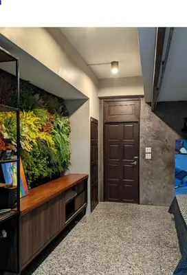 a hallway with a door and a plant on the wall at Old Town- mimi cozy studio *70 SQM good for family in Bangkok