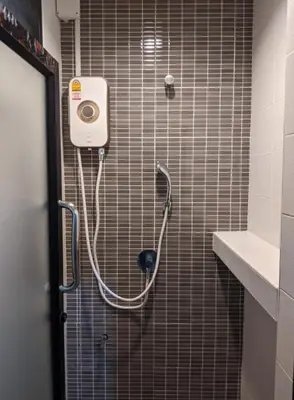 a shower in a bathroom with a hose on the wall at Old Town- mimi cozy studio *70 SQM good for family in Bangkok