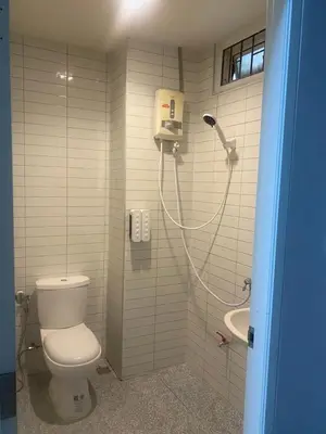 a bathroom with a shower with a toilet and a sink at N place Huai Khwang in Bangkok