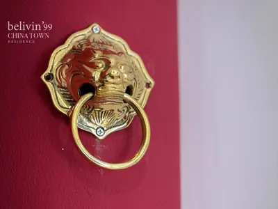 a gold door knocker with a lion on it at Belivin99 Residence Chinatown in Bangkok
