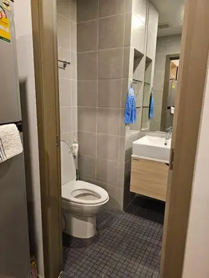 a bathroom with a toilet and a sink at Ideo O2 BTS Bangna in Bangkok
