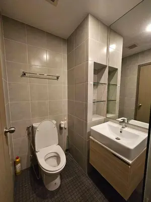a bathroom with a toilet and a sink at Ideo O2 BTS Bangna in Bangkok