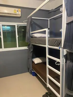 a room with bunk beds in a room at W District Guesthouse in Bangkok
