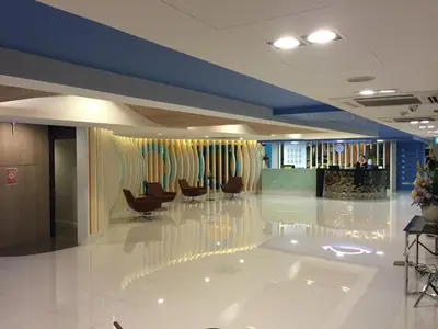 a lobby with desks and chairs in a building at Grand Tower Inn Sathorn Hotel in Bangkok