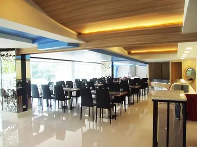 a restaurant with tables and chairs in a room at Grand Tower Inn Sathorn Hotel in Bangkok