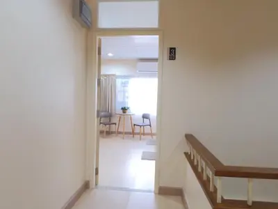 a hallway with a door leading to a dining room at Studio 36 in Bangkok