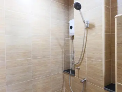 a shower with a shower head in a bathroom at Studio 36 in Bangkok