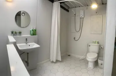 a bathroom with a sink and a toilet and a shower at COSY 4th floor with rooftop in Bangkok