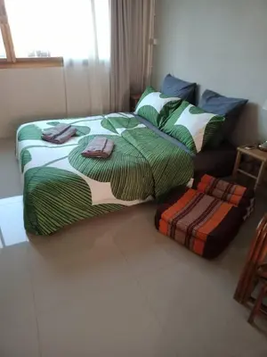 a bedroom with two beds and a couch at COSY 4th floor with rooftop in Bangkok