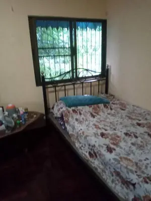 a bedroom with a bed and a window and a table at NP Prime FREE WiFi in Bangkok