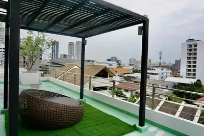 a balcony with a bench and a view of the city at Hip & Funky Sathon15 apartment close to BTS St Louis in Bangkok