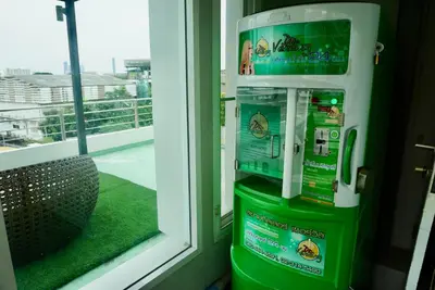 a couple of green machines sitting next to a window at Hip & Funky Sathon15 apartment close to BTS St Louis in Bangkok