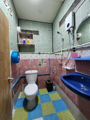 a bathroom with a toilet and a sink at 113 Cozy Loft style with cool fan with free Wi-fi in Bangkok