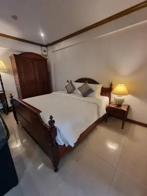 a bedroom with a large bed with white sheets and pillows at 12PM Bangkok in Bang Kapi