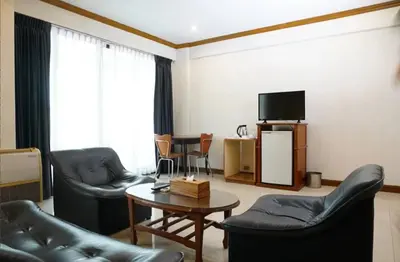 a living room with couches and a table and a tv at 12PM Bangkok in Bang Kapi