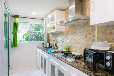 a kitchen with a counter top with a microwave at Friend House BKK in Bangkok