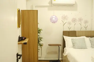 a bedroom with a bed and a desk with a chair at 2BR Stylist Rare Find China Town in Bangkok