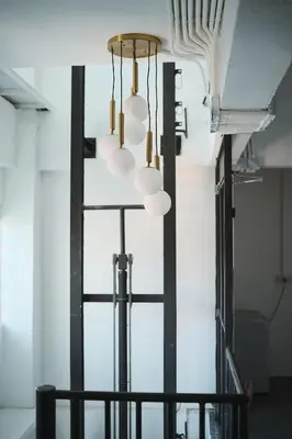 a cluster of lights hanging from a wall at 2BR Stylist Rare Find China Town in Bangkok