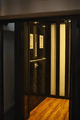 an entrance to a room with a glass door at 2BR Stylist Rare Find China Town in Bangkok