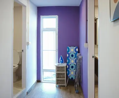 a bathroom with a purple wall and a toilet at 2BR Stylist Rare Find China Town in Bangkok