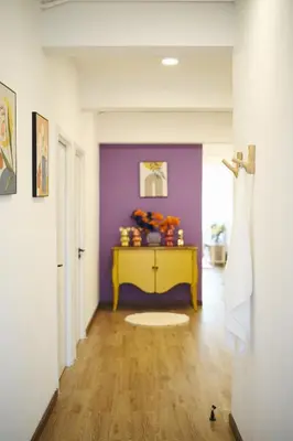 a hallway with a yellow table and a purple wall at 2BR Stylist Rare Find China Town in Bangkok