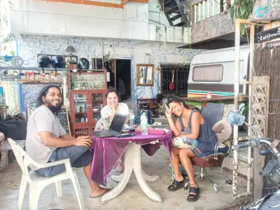 a group of people sitting at a table with a laptop at Best Place Have Air Conditioner in Bangkok