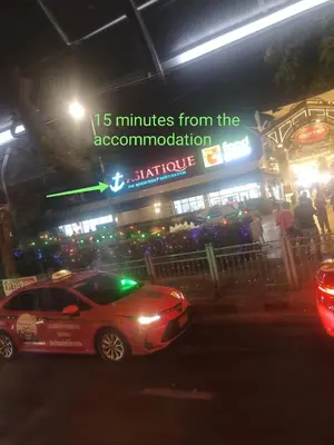 a car parked in front of a restaurant at night at Best Place Have Air Conditioner in Bangkok