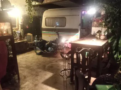 a motor bike parked in a garage with a caravan at Best Place Have Air Conditioner in Bangkok