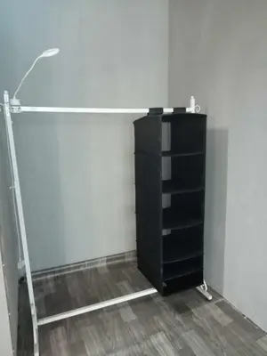 a room with a black book shelf and a lamp at Bang lumphu house&bistro in Bangkok