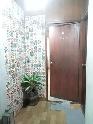 a door in a room with a plant next to it at Bang lumphu house&bistro in Bangkok
