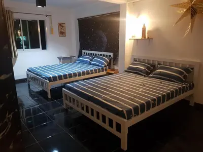 two beds sitting in a room with at BTL Sunny in Bang O