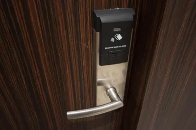 a door with a paper towel dispenser on it at Chateau de Sukhumvit in Bangkok