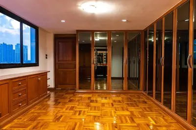 an empty room with a large window and wooden floors at Rooftop Paradise & Koi Pond-6BR Hideaway@Icon Siam in Bangkok