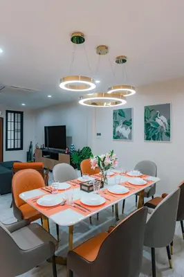 a dining room with a large table and chairs at PRIME SUKHUMVIT MODERN HOME, Phrom Phong BTS, Em District, Up to 14 guests in Bangkok