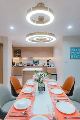 a dining room with a long table and chairs at PRIME SUKHUMVIT MODERN HOME, Phrom Phong BTS, Em District, Up to 14 guests in Bangkok