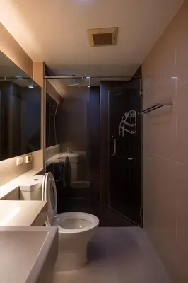 a bathroom with a toilet and a glass shower at LIV@5 Condominium in Makkasan