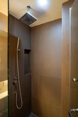 a bathroom with a shower with a shower head at LIV@5 Condominium in Makkasan