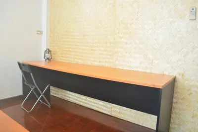 a desk in a room with a wall at Sweety Secret Guesthouse in Ban Tambon Bang Khae