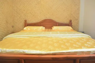 a bed with two pillows on top of it at Sweety Secret Guesthouse in Ban Tambon Bang Khae