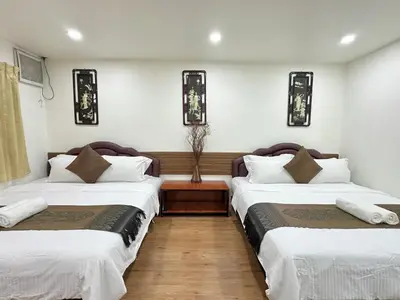 two beds sitting next to each other in a room at Longzhu Guesthouse in Bangkok