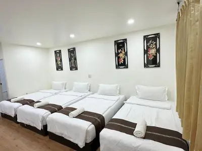 a group of four beds in a room at Longzhu Guesthouse in Bangkok
