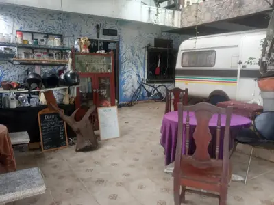 a room with a table and chairs and a van at Caravan Hotel have TV & Netflix in Bangkok