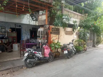 two motorcycles parked in front of a building at Caravan Hotel have TV & Netflix in Bangkok