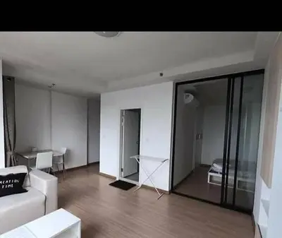 a living room with a white couch and a table at 1BR Apartment in Bangkok
